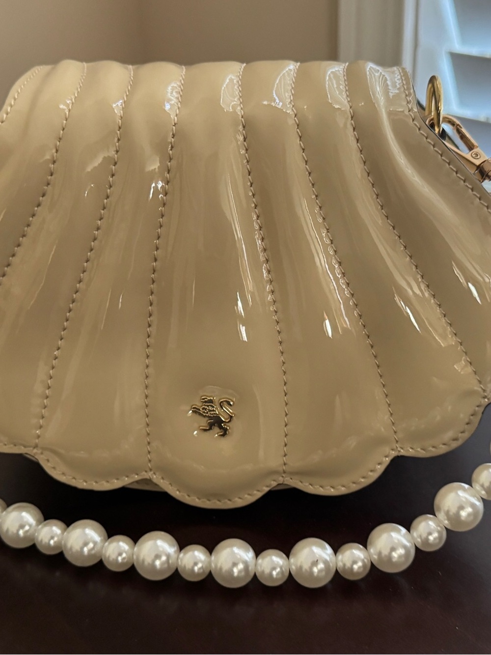 Pratesi Italian leather shell bag with simulated pearl handle.